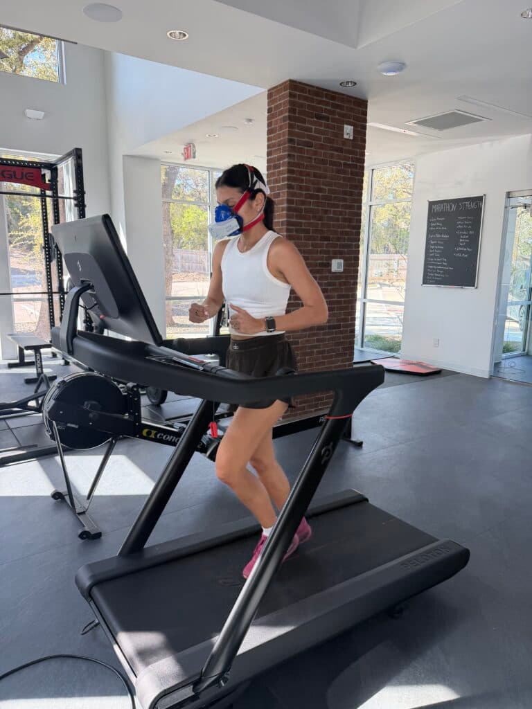 Member performing a VO₂ max treadmill test with a metabolic mask
